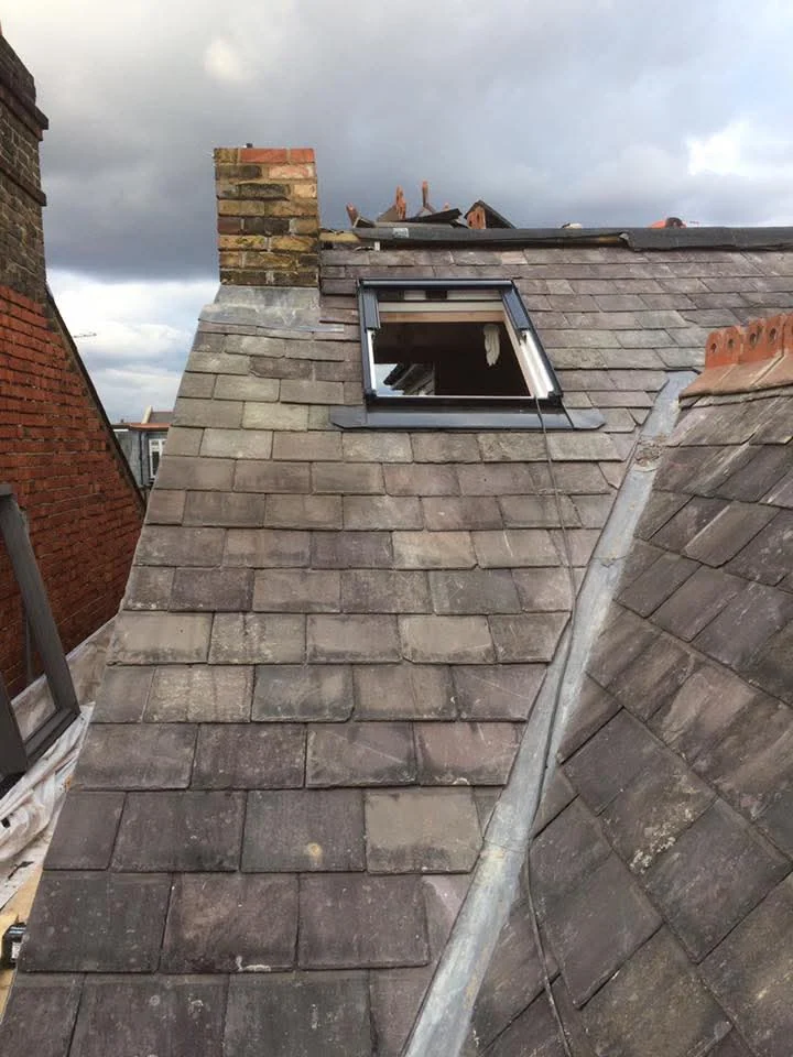 Slate pitched roof and roof window